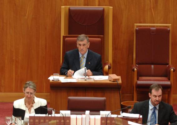 The President of the Senate seated in the President's chair in the Senate chamber
